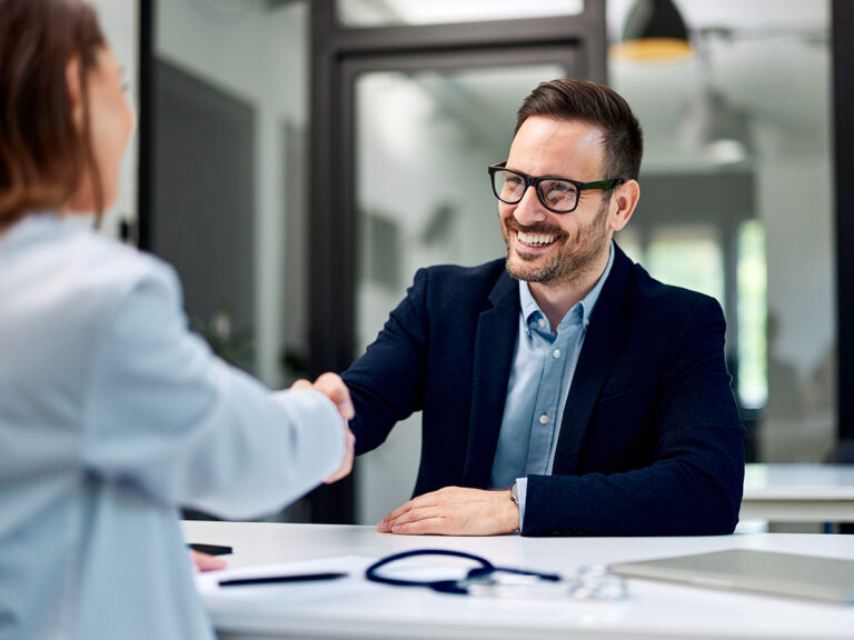 Finance staff discussing and agreeing on points surrounding healthcare contract compliance in a meeting